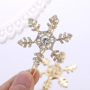 Elegant gold snowflake hair clip with sparkling rhinestones for women's hair styling
