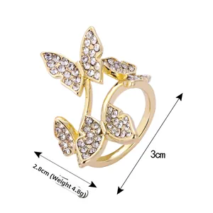 Macro view showing dimensions and weight of a golden butterfly ring with sparkling crystals