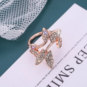 Elegant rose gold butterfly ring with sparkling diamonds and purple gemstones on lace