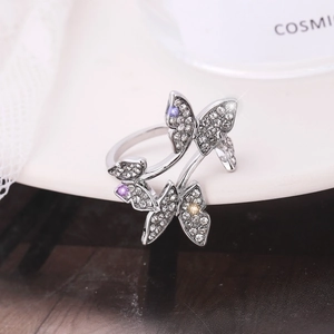Macro shot of silver butterfly ring with multi-color rhinestones and sparkling crystals