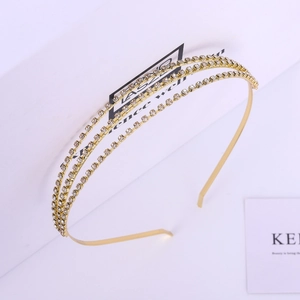 Detail of a triple-layered gold headband with sparkling crystal rhinestones for hair