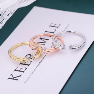 Three-color set of copper geometric open rings with sparkling zircon stones in a gold finish