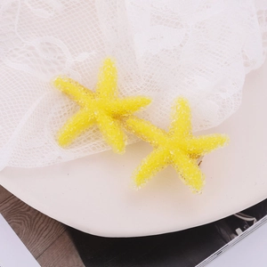 Pair of stylish yellow starfish hair clips with textured crystalline finish for women