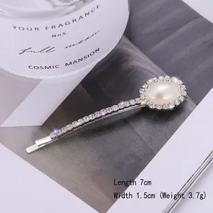 Detail view of heart pearl hair clip with rhinestones, sized 7cm by 1.5cm wide