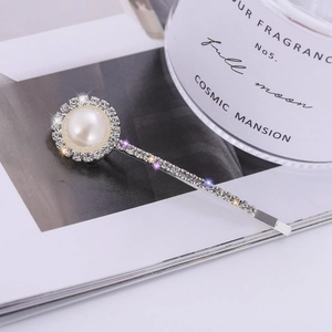 Elegant silver hair clip with a large central pearl and sparkling rhinestone embellishments