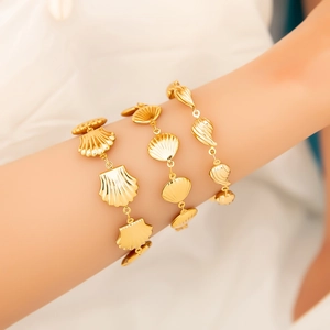 Three elegant 18K gold plated stainless steel bracelets with assorted ocean shell charms