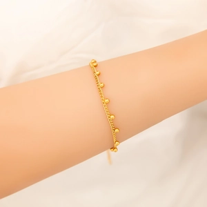 Minimalist 18K gold stainless steel bead chain bracelet on a model's wrist