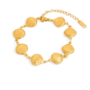 Detailed macro view of 18K gold plated seashell links and lobster clasp on the bracelet