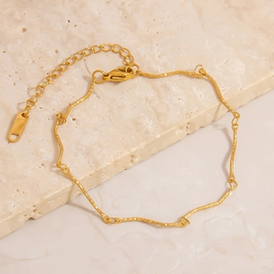 Detail of 18K gold stainless steel bracelet with hammered texture and lobster clasp
