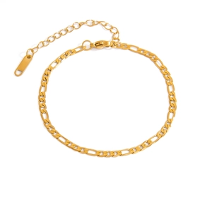 Detail of 18K gold Figaro chain with lobster clasp, extender and teardrop charm