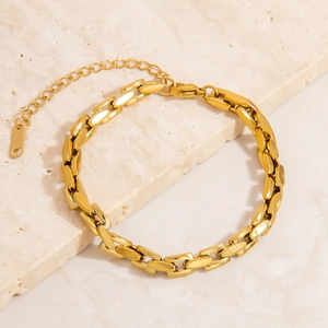 Luxurious 18K gold plated stainless steel phoenix chain bracelet on textured stone