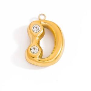 Detailed macro of golden bubble letter D pendant with two inlaid round zircons and ring