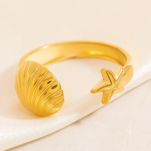 18K gold-plated stainless steel open sea star and shell ring on silk background