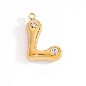 Macro view of gold L-shaped letter pendant with sparkling crystals and polished finish