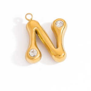 Detailed macro view of 18K gold letter N pendant featuring sparkling crystal accents
