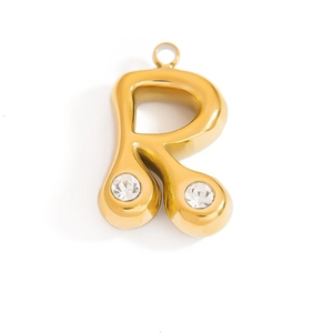 Detail of 18K gold-plated letter R pendant with sparkling round-cut zircon stones