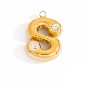 Detail of a polished gold letter S pendant with sparkling zircon accents and a top loop