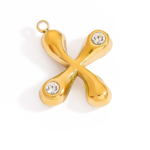 Detailed view of 18K gold letter X pendant featuring two sparkling cubic zirconia stones