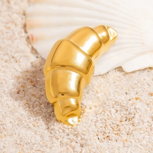Polished 18K gold plated croissant ring on white sand with a decorative shell