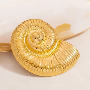 Golden nautilus seashell brooch with a highly polished texture and ocean-inspired design