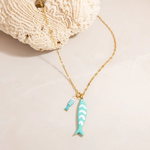 Detail view of gold tropical fish necklace with blue enamel and coral decoration