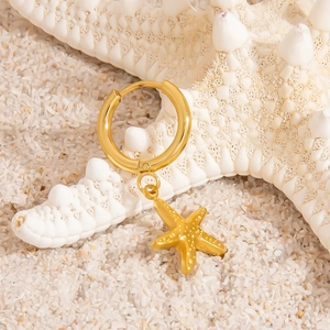 18K gold plated stainless steel starfish hoop earrings on white sand beach