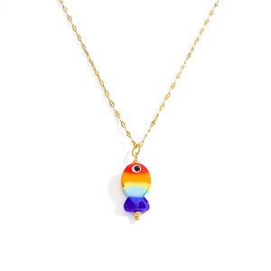 Detailed close-up of colorful tropical fish pendant with evil eye and gold chain