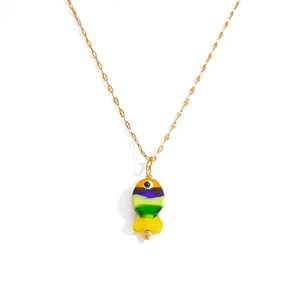 Macro detail of tropical fish pendant in orange and purple stripes on a gold necklace