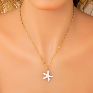 Starfish pendant necklace in 18K gold finish with white enamel detail on model