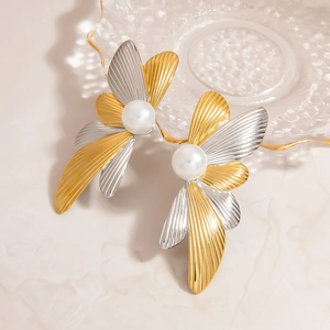 Elegant two-tone butterfly stud earrings with pearl inlay and textured metal wings