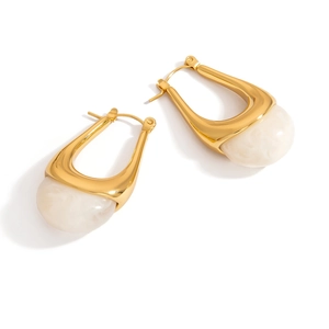 Detailed close-up of 18K gold-plated U-shaped earrings with marble resin inlay detail