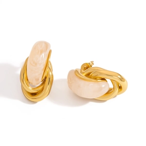Detail of U-shape stud earrings with gold metal and cream marble resin texture