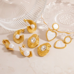 Elegant gold heart and pearl earrings with irregular drop crystals on stone