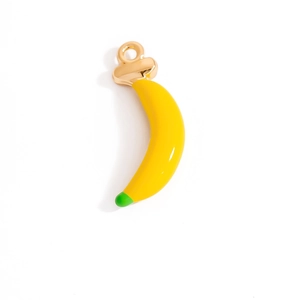 Macro shot of cute yellow banana pendant with gold ring and green tip detail
