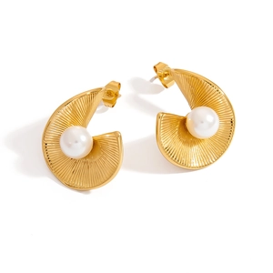 Detail of gold pleated fan earrings with white pearl inlay and butterfly clasp backing