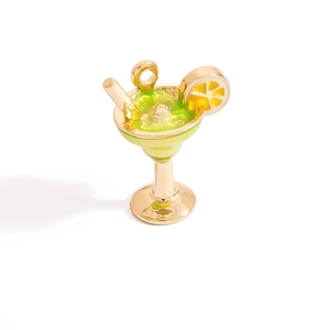 Detail view of a cocktail glass pendant with green enamel and yellow lemon slice accent