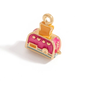 Detail of creative enamel toaster charm with pink and yellow finish for DIY jewelry