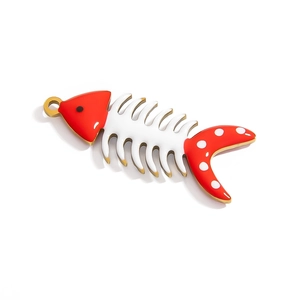 Detailed view of red and white fish bone pendant with gold metal edges and oil drip finish