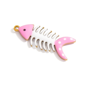 Macro detail of fish bone pendant with pink enamel coating and golden metal frame