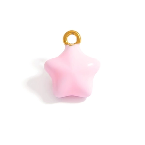 Macro view of pink star charm with gold ring and glossy enamel finish for DIY jewelry