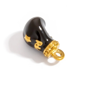 Macro view of boxing glove pendant charm with black enamel and gold star detail
