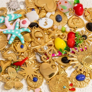 Assorted gold stainless steel charms with enamel ocean and celestial DIY designs