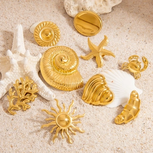 Golden ocean series brooches including starfish and shell on sand for summer vacation