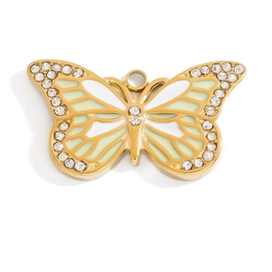 Detail of 18K gold plated butterfly pendant with white and green enamel and rhinestones