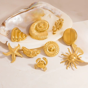 Golden stainless steel ocean collection brooches including sea shells and coral shapes
