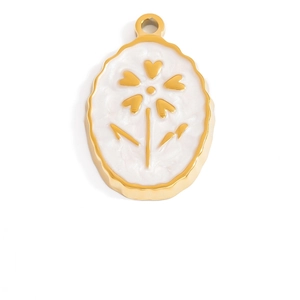 Detailed macro view of an oval gold pendant featuring white enamel and a heart flower design