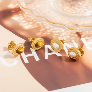 Vintage 18K gold plated oval earrings with pearls and tiger eye stones on glossy tray
