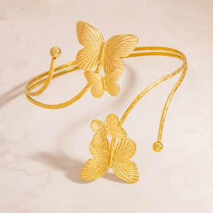 Bracelet de bras ajustable en acier doré avec des motifs de papillons évidés élégants