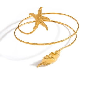 Bracelet de bras spirale plaqué or 18K avec étoile de mer et conque sur fond blanc