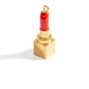Detail of red enamel lipstick charm with gold base and metal ring for jewelry making